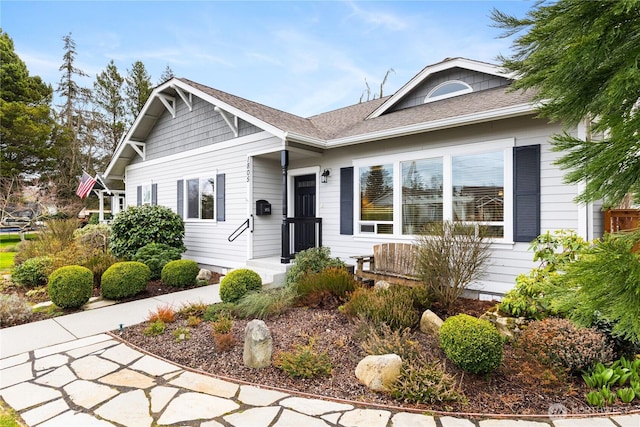 view of front of home with a shingled roof