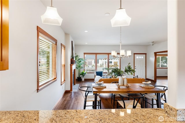 dining area with recessed lighting, wood finished floors, baseboards, and a chandelier