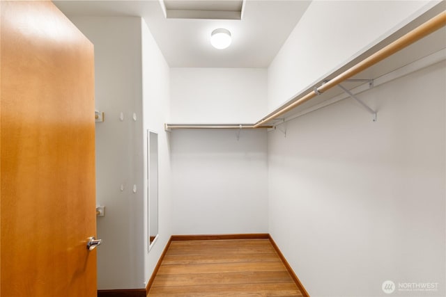 spacious closet with wood finished floors