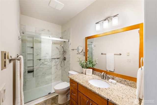 bathroom with vanity, toilet, and a shower stall