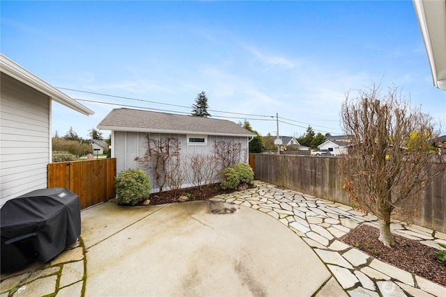 view of patio / terrace featuring an outbuilding, fence, and grilling area