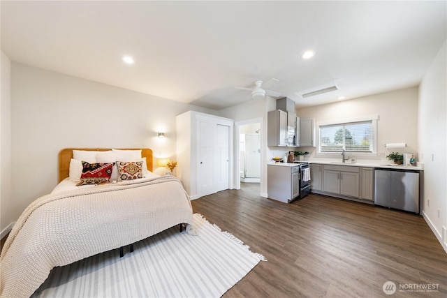 bedroom featuring baseboards, dark wood-style flooring, recessed lighting, a ceiling fan, and a sink