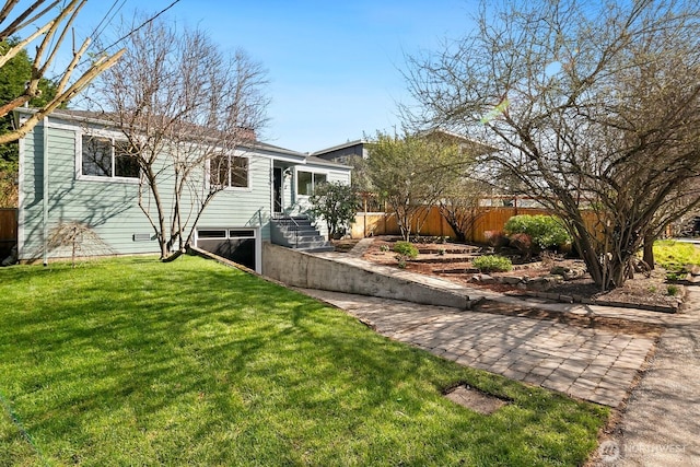 exterior space with a front yard and fence