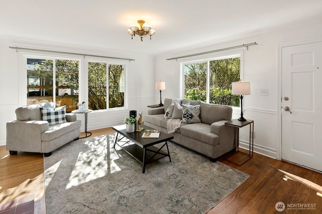 living room with ornamental molding and wood finished floors