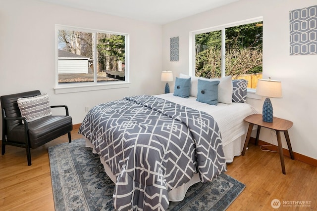 bedroom featuring wood finished floors and baseboards