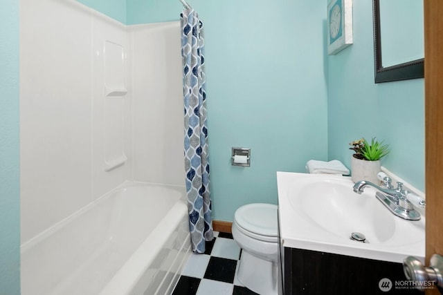 bathroom with vanity, baseboards, shower / bath combo, tile patterned floors, and toilet