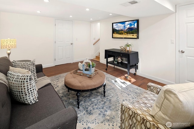 living room with stairs, recessed lighting, wood finished floors, and visible vents