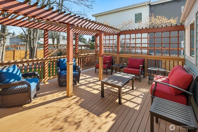 wooden deck with outdoor lounge area, fence, and a pergola