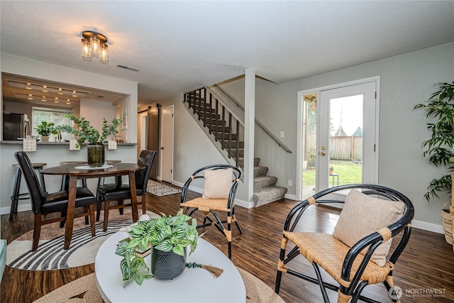 dining area with visible vents, baseboards, dark wood-type flooring, and stairs