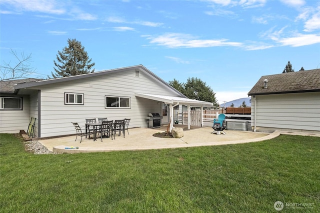 back of house with a patio area, fence, and a lawn