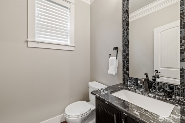 bathroom featuring vanity, toilet, and crown molding