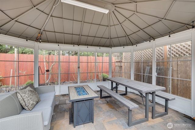 view of patio / terrace with an outdoor living space with a fire pit, a gazebo, outdoor dining area, and a fenced backyard