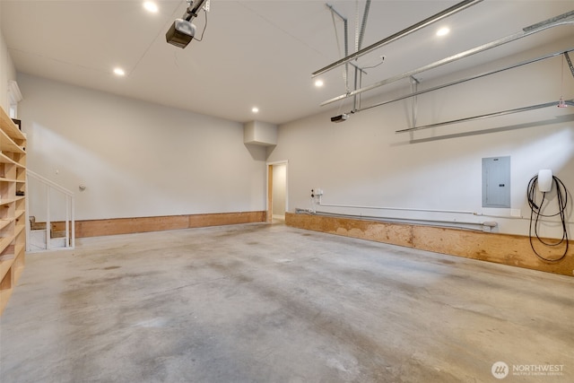 garage with electric panel and a garage door opener