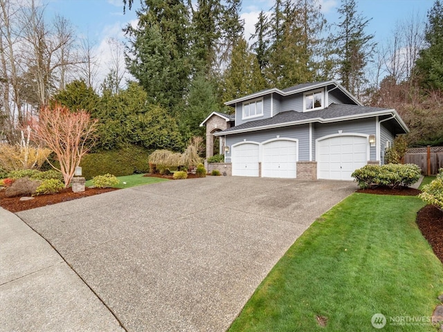 view of front of home with fence, concrete driveway, a front yard, a garage, and brick siding