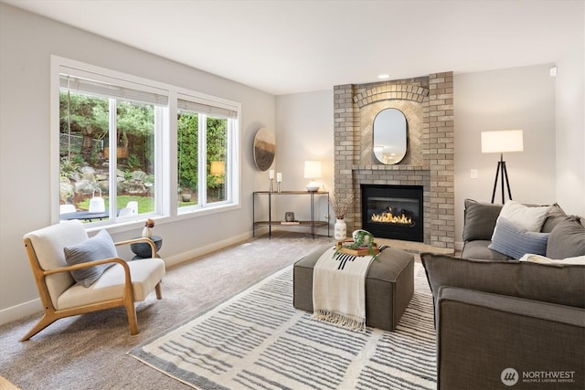 living area featuring a fireplace, baseboards, and carpet floors