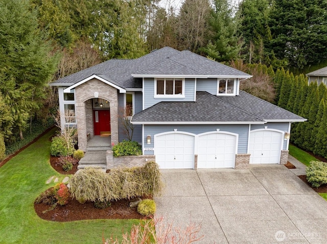 view of front of property with driveway, brick siding, a front yard, and a shingled roof