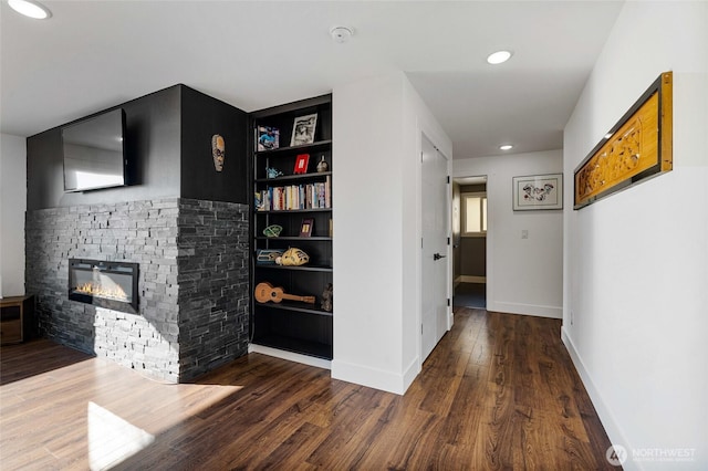 hall featuring recessed lighting, baseboards, and wood finished floors