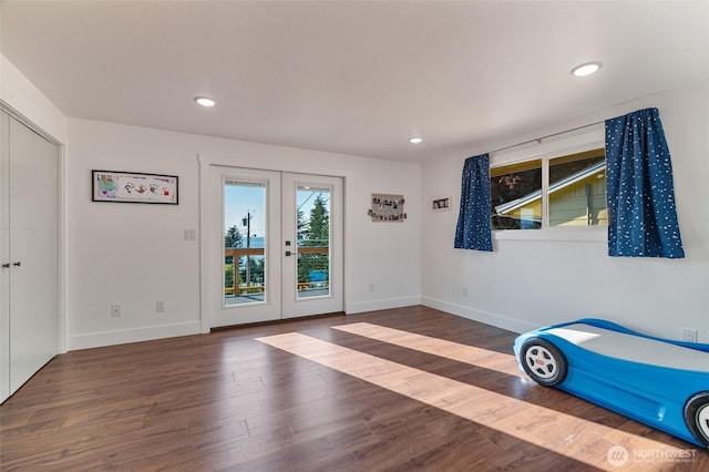 unfurnished bedroom with wood finished floors, baseboards, recessed lighting, french doors, and access to outside