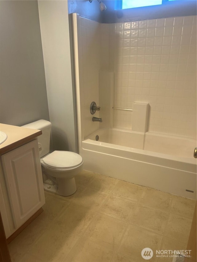 bathroom with tile patterned flooring, shower / bathtub combination, toilet, and vanity