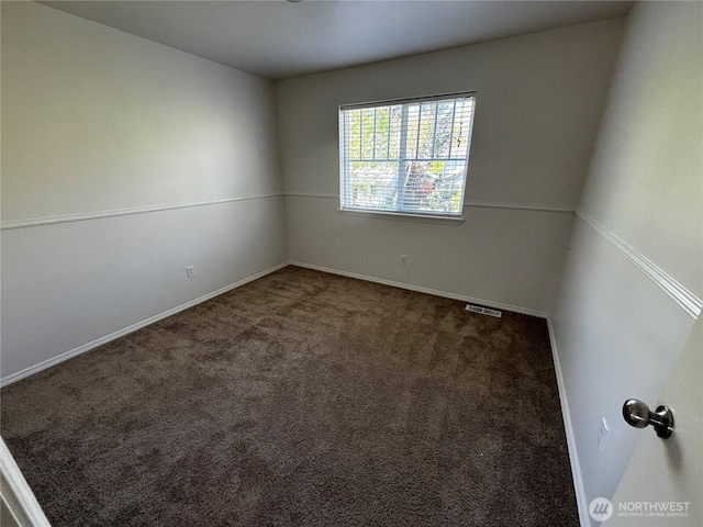 carpeted spare room with baseboards and visible vents