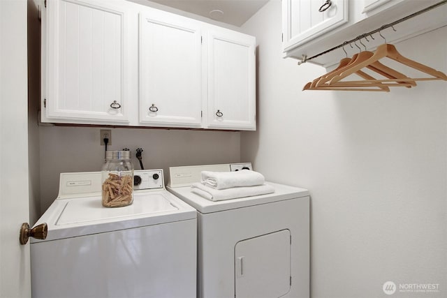 laundry room with separate washer and dryer and cabinet space