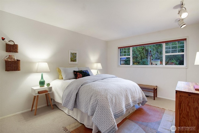 carpeted bedroom featuring baseboards