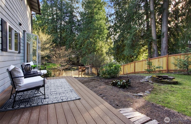 wooden terrace with fence and a fire pit