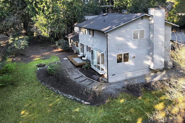 exterior space featuring a wooden deck, roof with shingles, a chimney, crawl space, and driveway