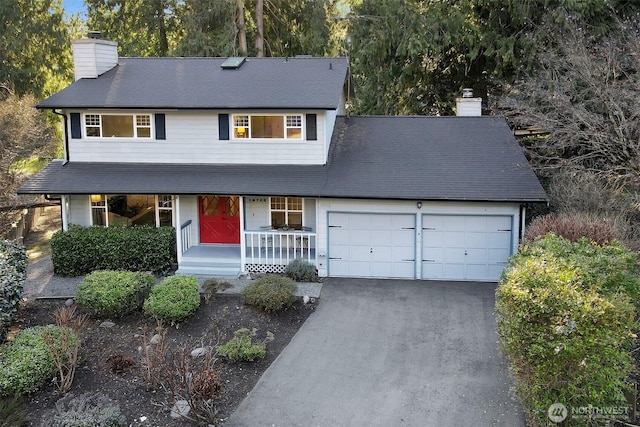 view of front of property with aphalt driveway, a garage, a porch, and a chimney