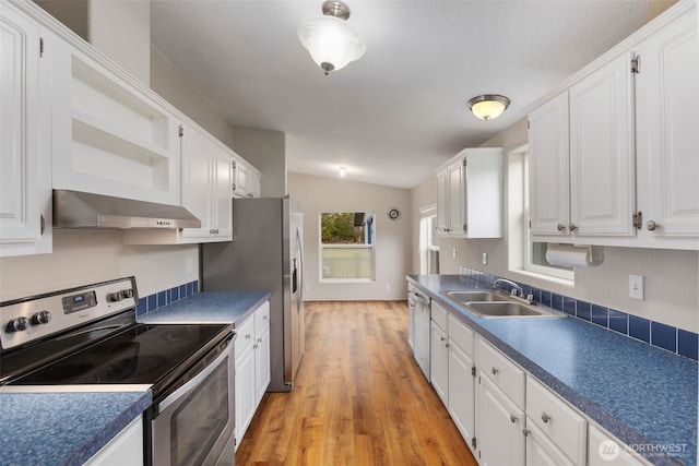 kitchen with ventilation hood, open shelves, a sink, white cabinets, and appliances with stainless steel finishes