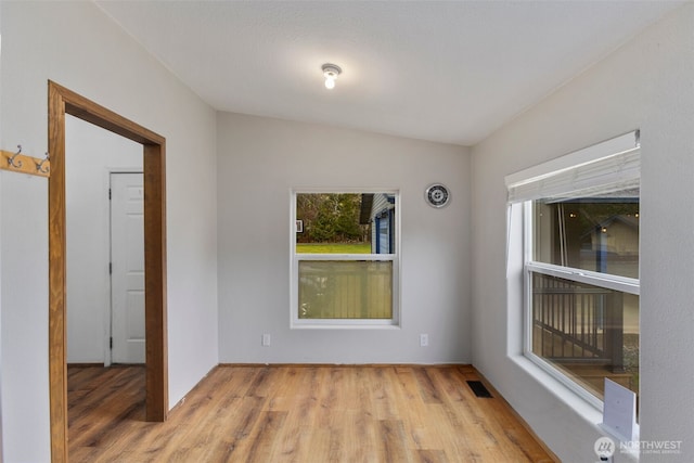 spare room featuring visible vents and wood finished floors