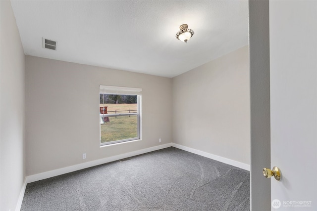 spare room featuring visible vents, baseboards, and carpet