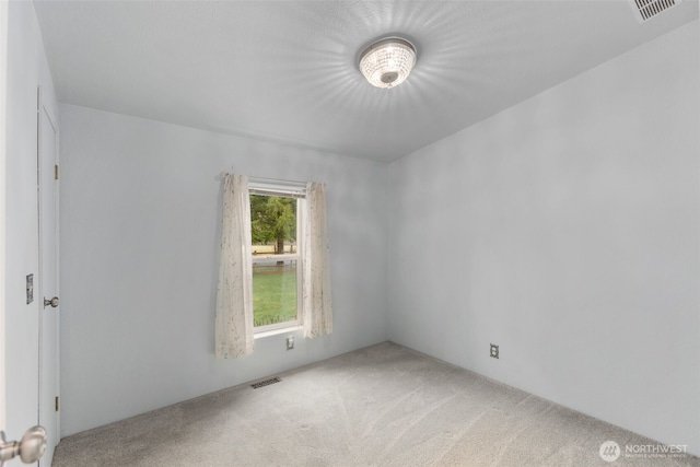 unfurnished room featuring visible vents and carpet floors