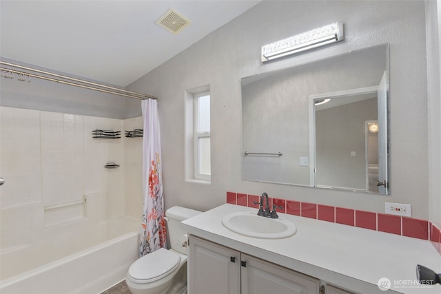 bathroom featuring vanity, toilet, shower / bath combo, and visible vents