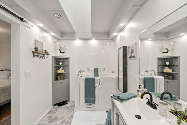 bathroom with a bath and vanity