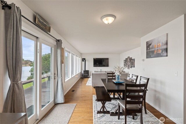 dining area featuring light wood-style floors and baseboards