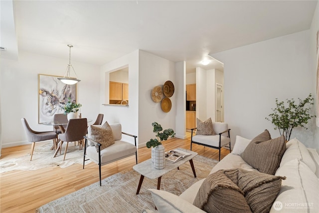 living room with light wood-type flooring and baseboards