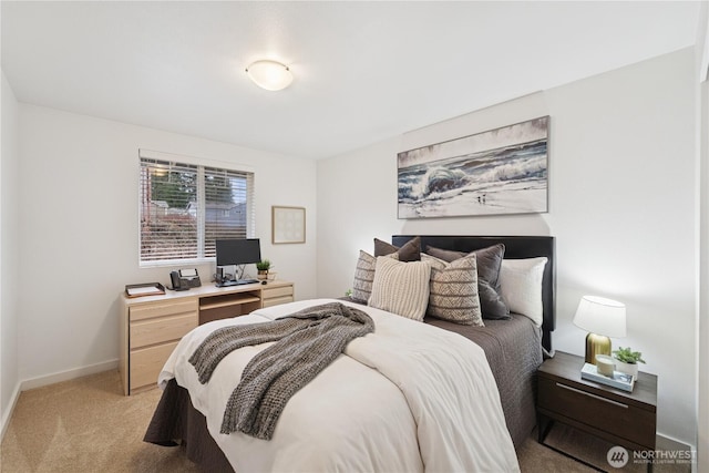 bedroom featuring baseboards and light carpet