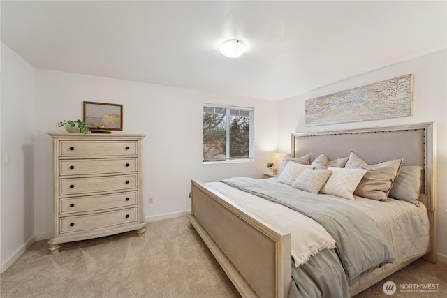 bedroom with baseboards and light carpet