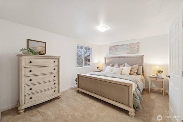 bedroom with light carpet and baseboards