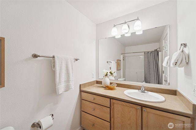 bathroom featuring vanity and a shower with shower curtain