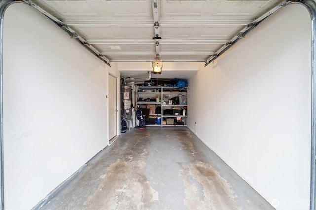 garage with a garage door opener and water heater