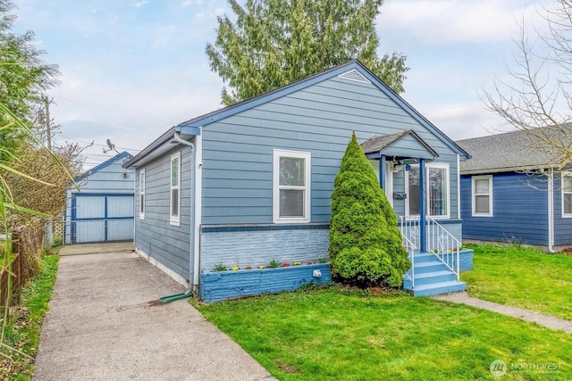 bungalow-style home with a front lawn and fence