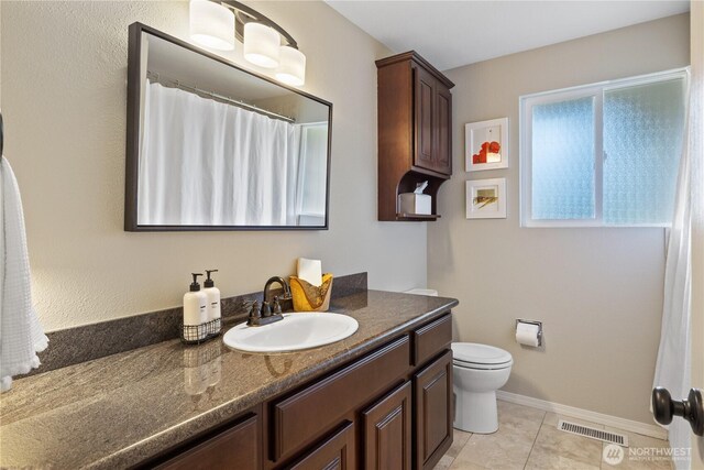 full bathroom featuring visible vents, baseboards, toilet, tile patterned floors, and vanity