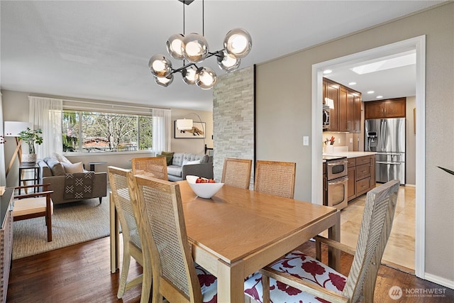 dining space featuring a chandelier and light wood finished floors