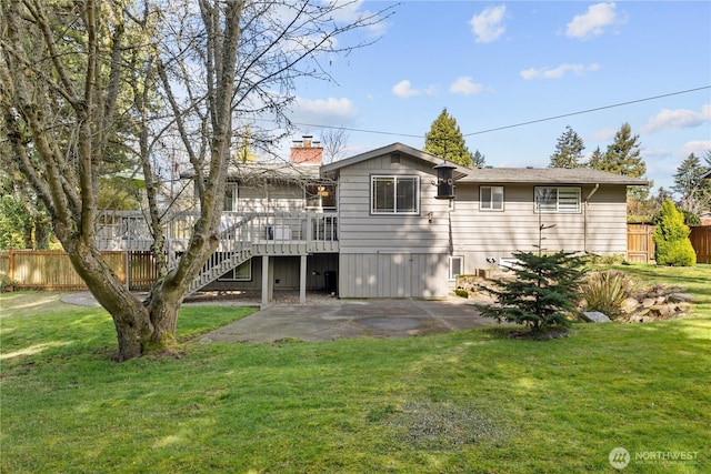 rear view of house featuring a lawn, fence, stairway, a wooden deck, and a patio area