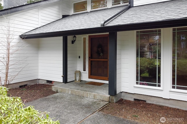 doorway to property featuring crawl space and a shingled roof