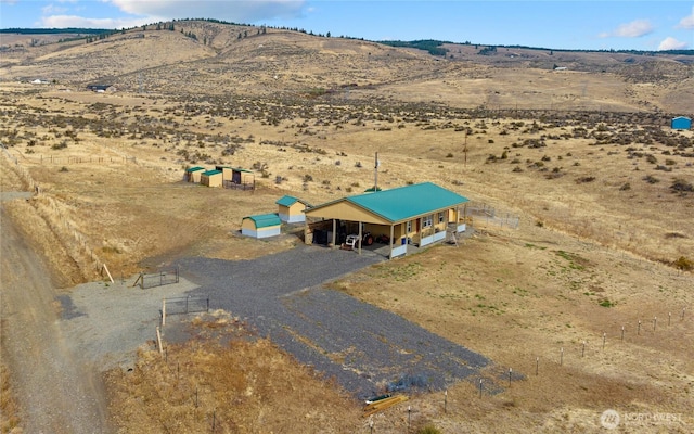 birds eye view of property with a mountain view and a rural view