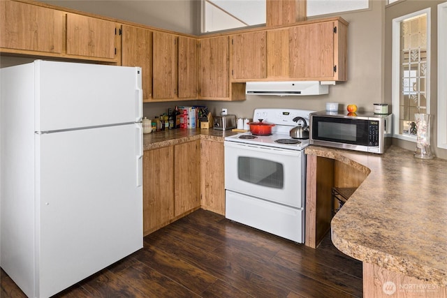 kitchen featuring white appliances, dark wood-style floors, extractor fan, and light countertops