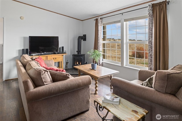 living room with hardwood / wood-style floors, a wood stove, and ornamental molding